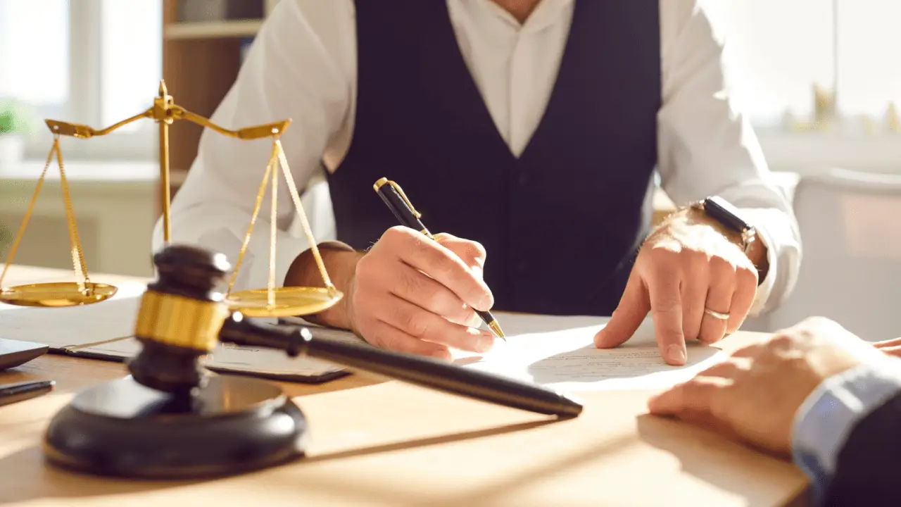 Professional lawyer reviewing documents with client discussing when to hire a motorcycle accident lawyer