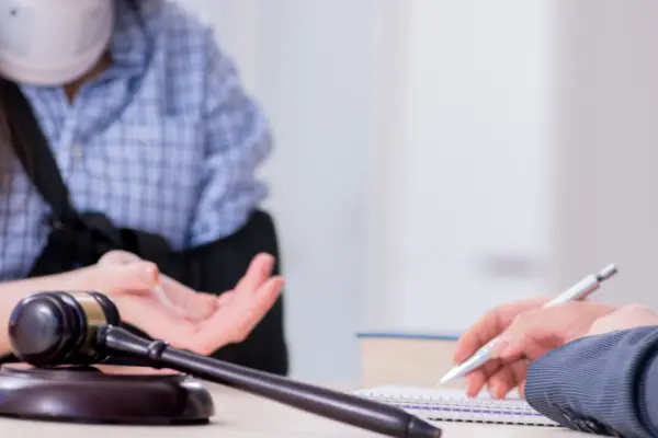 Legal consultation discussing what is a personal injury payout with gavel and notepad on desk