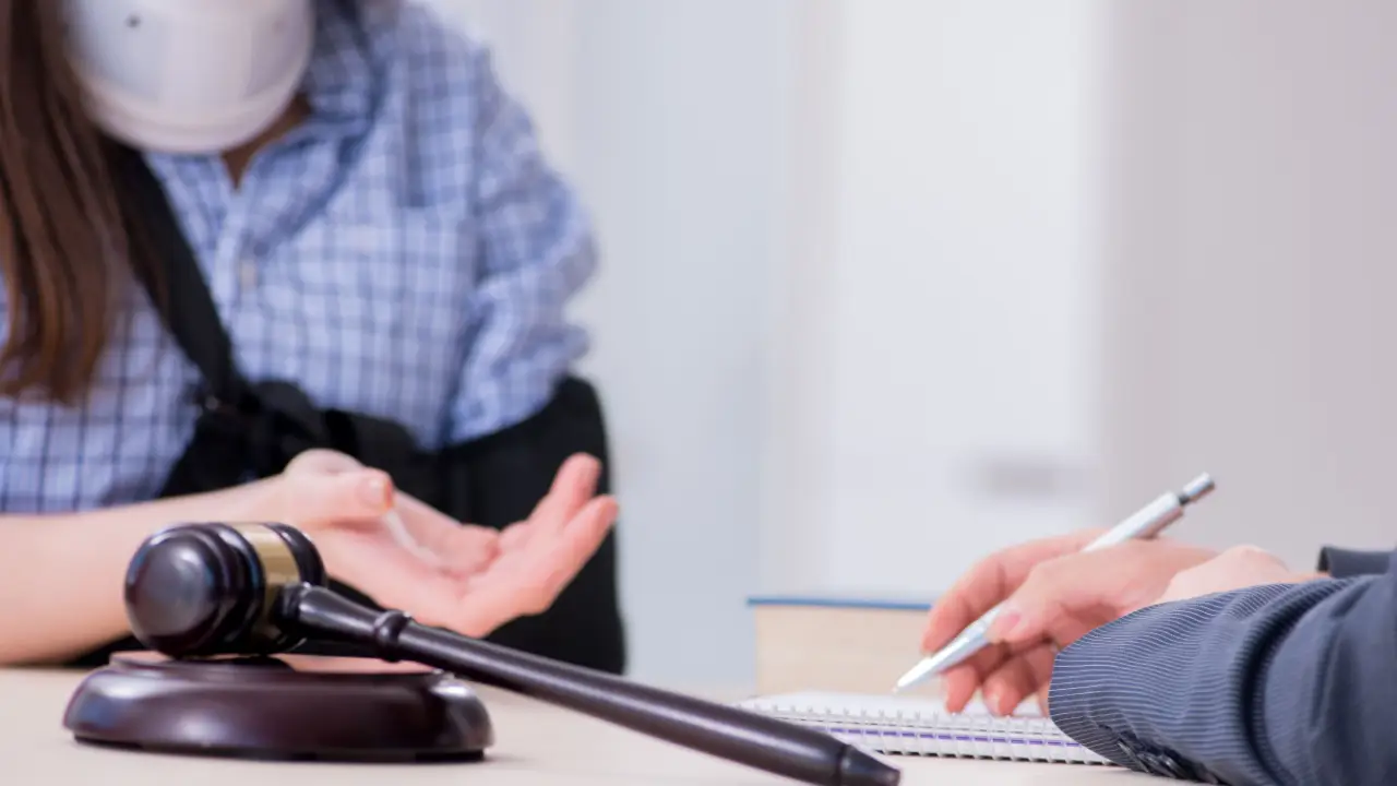 Legal consultation discussing what is a personal injury payout with gavel and notepad on desk