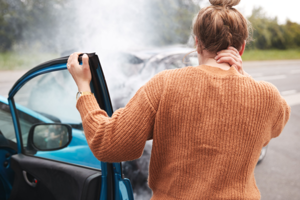 Woman holding neck after car accident wondering what is the average payout for whiplash injury
