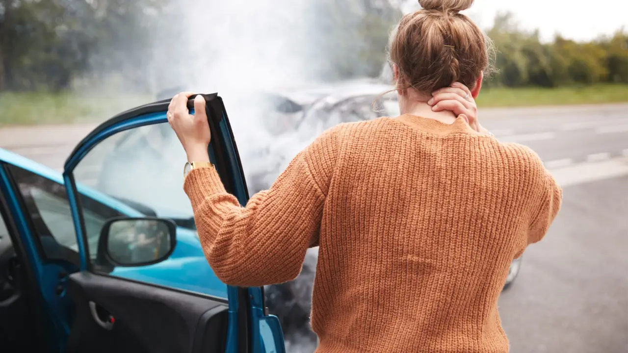Woman holding neck after car accident wondering what is the average payout for whiplash injury