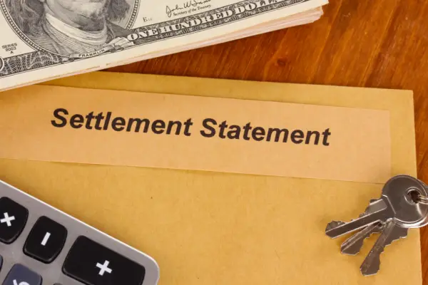 Settlement statement with cash and calculator showing how to get the most out of a personal injury claim