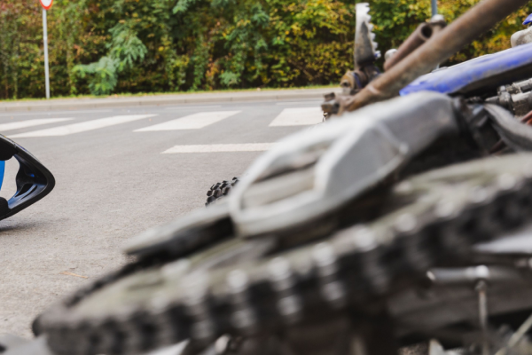 Motorcycle accident scene showing damaged bike on road - how do i find a good motorcycle accident lawyer