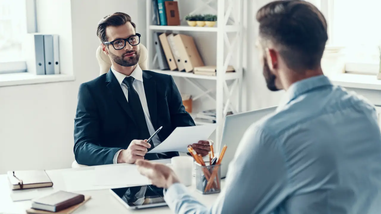 Motorcycle accident lawyer discussing settlements in motorcycle accidents with client during consultation meeting