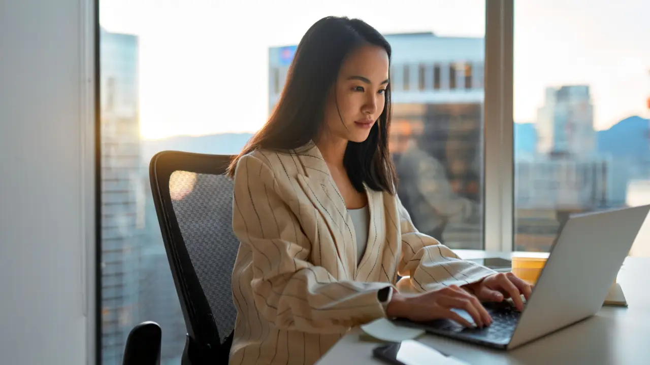 Professional woman researching how often do personal injury lawyers win using laptop in modern office with city skyline view