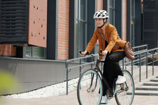 Professional cyclist wearing helmet demonstrating bicycle safety while commuting in urban area
