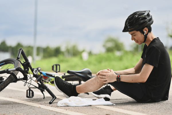 Injured cyclist sitting on road after bike crash documenting evidence of how do you prove fault in a bicycle accident case