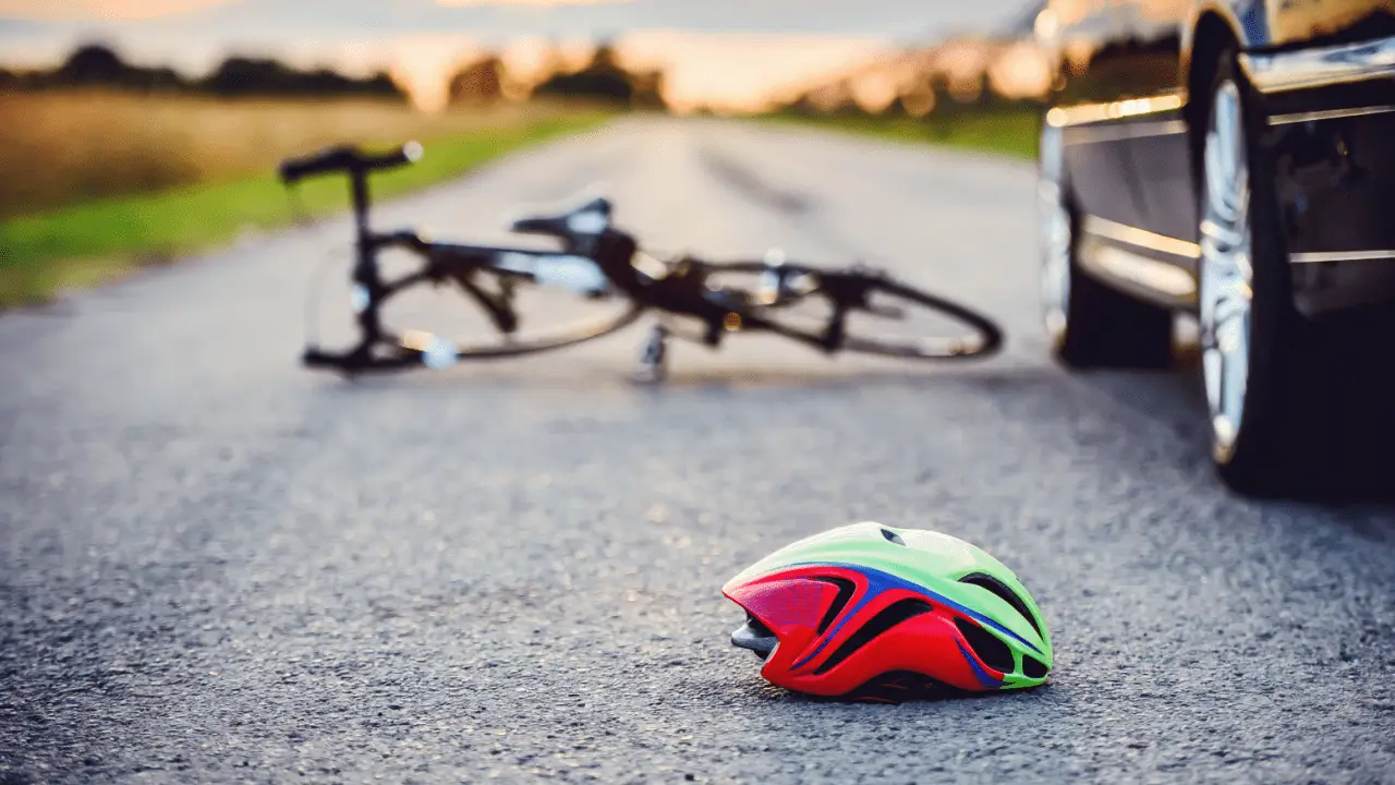 Bicycle helmet on road after car collision showing evidence needed for how to file a claim after a bicycle accident