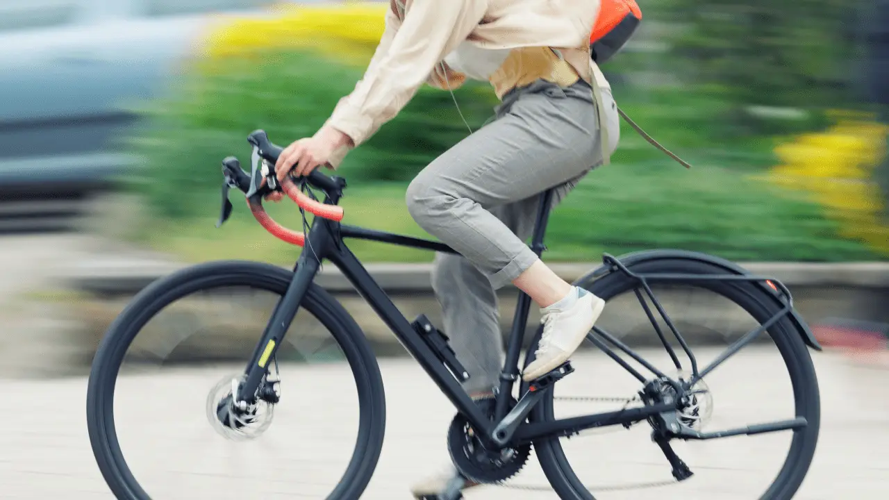 Cyclist riding bike on road with traffic showing what are the biggest safety concerns for bicyclists