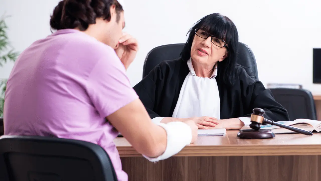 Injured cyclist with arm cast meeting attorney in office discussing what should i do after a bicycle accident lawyer consultation