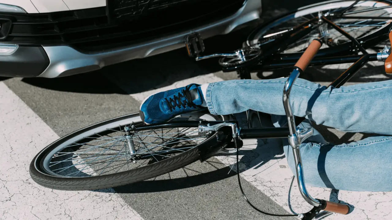 Cyclist lying on pavement after bicycle accident in Florida showing what to do after a bicycle accident in Florida