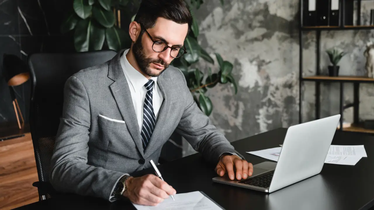 rofessional personal injury lawyer reviewing case documents at modern office desk