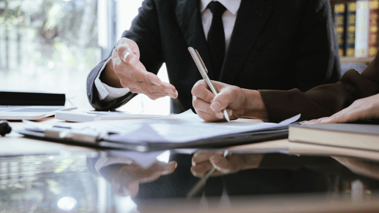 Attorney and client reviewing legal documents to evaluate what are signs of a good settlement offer in personal injury case