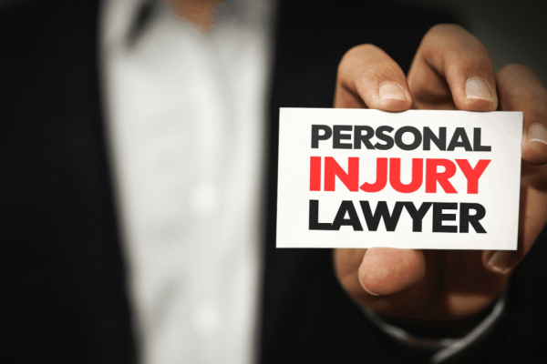 Attorney in suit holding business card displaying personal injury lawyer demonstrating what is the role of a personal injury lawyer