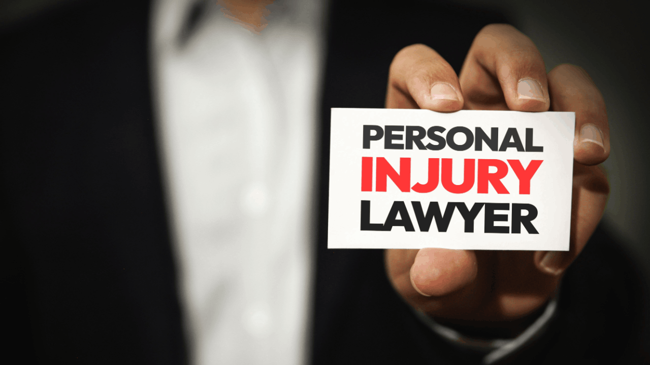 Attorney in suit holding business card displaying personal injury lawyer demonstrating what is the role of a personal injury lawyer