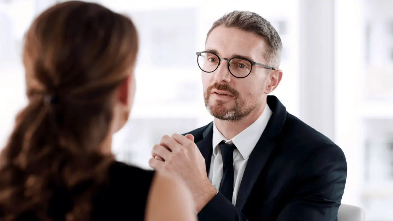 Attorney consulting with client about what should I avoid discussing during my injury claim in professional office