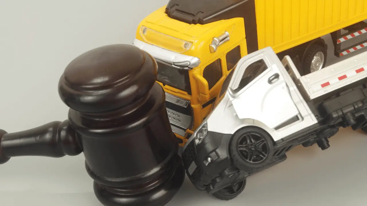 Benefits of hiring a truck accident lawyer represented by gavel and toy vehicles symbolizing legal representation in commercial truck crash claims