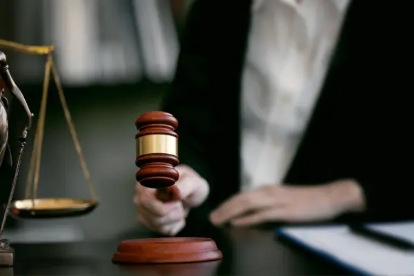 Hiring a truck accident lawyer concept with judge's gavel, scales of justice, and legal professional at desk