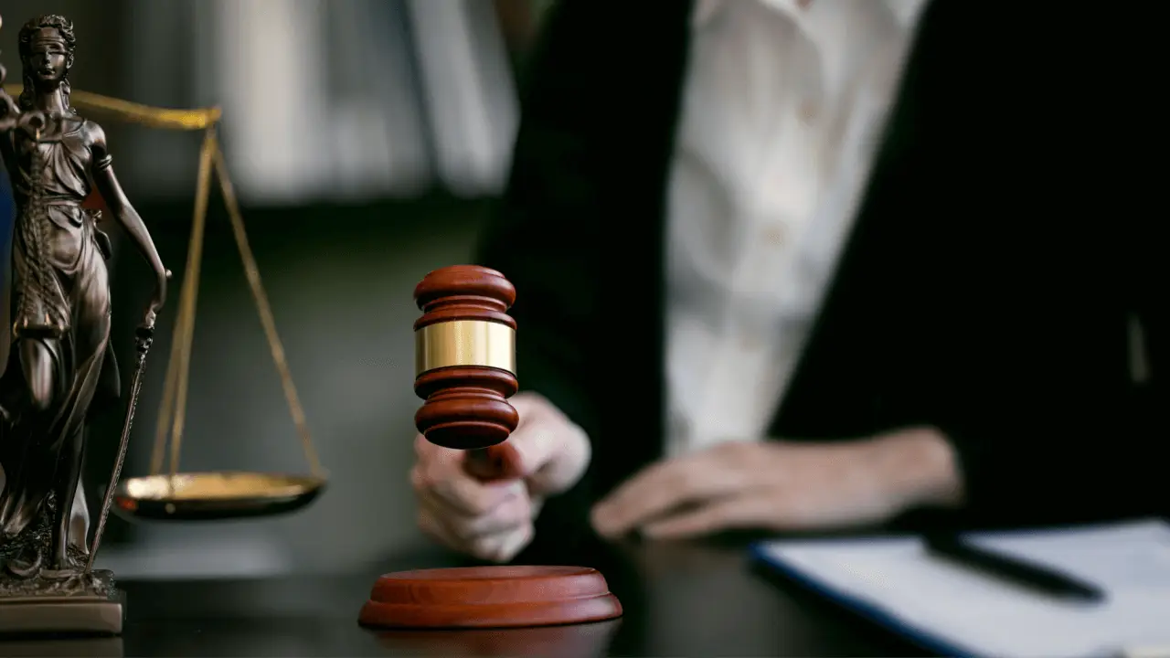 Hiring a truck accident lawyer concept with judge's gavel, scales of justice, and legal professional at desk