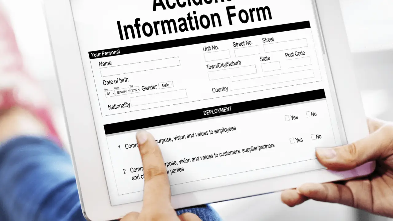 Person completing truck accident legal process information form on tablet for injury claim documentation