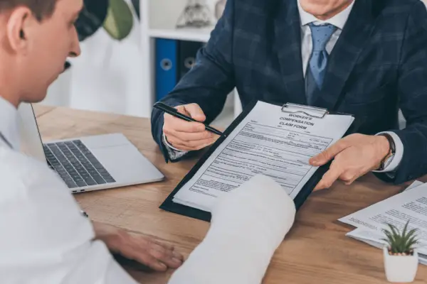 Attorney reviewing what documentation strengthens a personal injury case with injured client during claim consultation