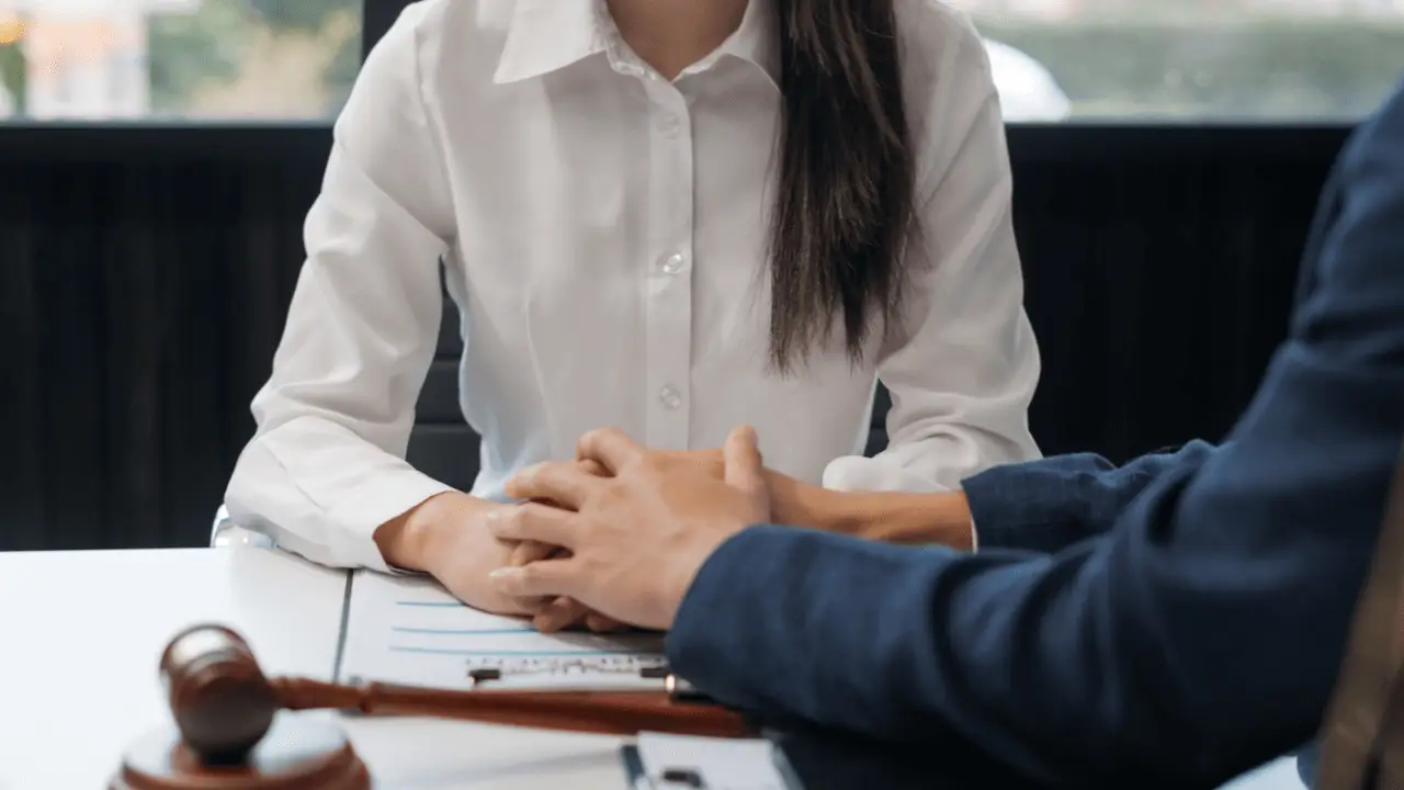 Attorney consulting with client about what mistakes can hurt a personal injury case during legal review meeting