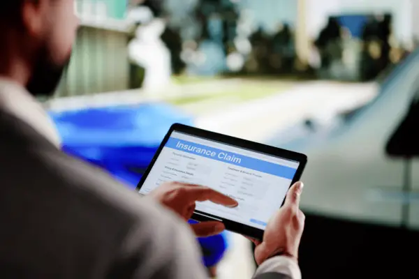 insurance claim mistakes on tablet after car accident