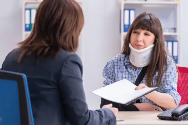 car accident claim process consultation with injured woman and professional