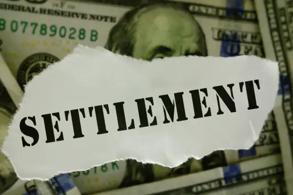 Truck accident settlement timeline concept showing settlement document on cash compensation