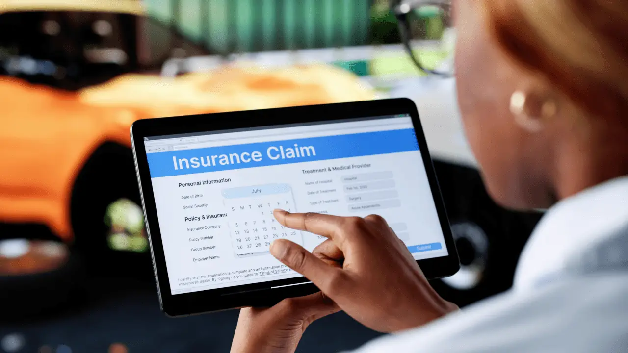 Person selecting a date on an insurance claim form on a tablet after a car accident, illustrating when to file insurance claim