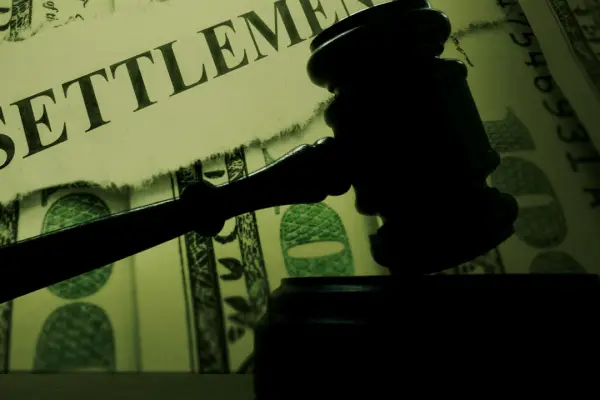 Truck accident settlement process representation with legal gavel on cash symbolizing compensation claims
